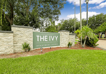 Orlando apartment for rent - A sign that says "The Ivy Apartment Homes" in front of a stone wall.
