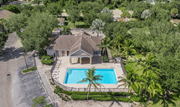 Naples apartment for rent - A house with a pool surrounded by trees.