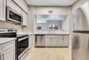 Las Vegas apartment for rent - a kitchen with stainless steel appliances and white cabinets