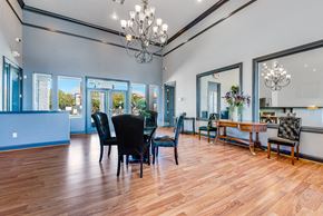 Las Vegas apartment for rent - a dining room with a table and chairs and a chandelier