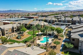 Las Vegas apartment for rent - an aerial view of a neighborhood with a swimming pool and palm trees
