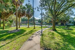 Oldsmar apartment for rent - a path through a park with trees and benches