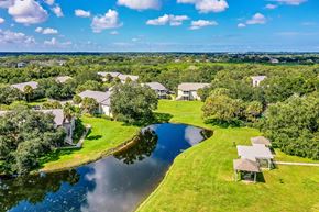 Oldsmar apartment for rent - an aerial view of houses next to a body of water