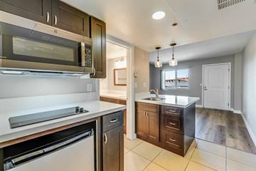 National City apartment for rent - A kitchen with a black microwave and a black dishwasher.