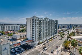 National City apartment for rent - A large white building is in the middle of a city intersection.