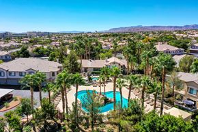 Las Vegas condo for rent - an aerial view of a swimming pool with palm trees     and houses