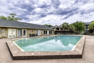 Pensacola apartment for rent - A small pool in front of a building.