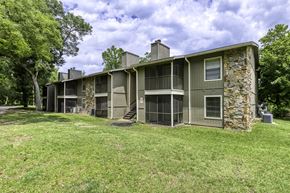 Pensacola apartment for rent - A large house with a stone pillar and a balcony.