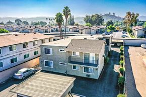 Lakeside apartment for rent - A car is parked in a driveway in front of a two-story house.