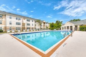 Panama City apartment for rent - A large swimming pool in front of apartment buildings.