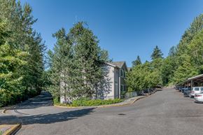 Seattle apartment for rent - exterior entrance to property with driveway and parking spaces
