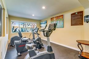 Chula Vista apartment for rent - A gym room with exercise equipment and a wooden table.