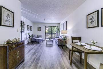 Auburn apartment for rent - A living room with a grey couch and a wooden cabinet.