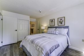 Auburn apartment for rent - A bedroom with a large bed and a white door.