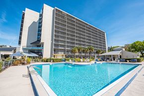 Merritt Island apartment for rent - a hotel with a large pool in front of it