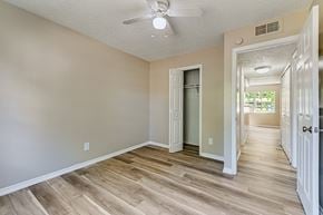 Tampa apartment for rent - A room with a ceiling fan and wooden flooring. at Green Oaks Apartments, Tampa, Florida