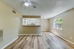 Tampa apartment for rent - A room with a ceiling fan and wooden flooring. at Green Oaks Apartments, Tampa, Florida