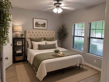 Dallas apartment for rent - A bedroom with a large bed and a ceiling fan.