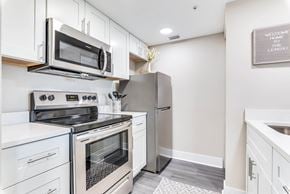 Merritt Island apartment for rent - a kitchen with white cabinetry and stainless steel appliances