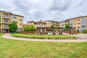 Dallas apartment for rent - Apartment complex with a grassy area in front.