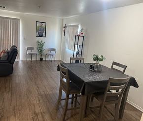 Huron apartment for rent - A dining room with a table set for two and a couch.