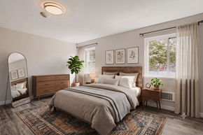 Portland apartment for rent - A bedroom with a large bed, a dresser, and a mirror.