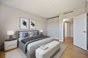Stockton apartment for rent - A bedroom with a large bed and two nightstands.