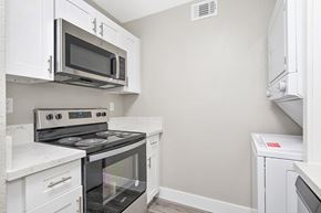 Fair Oaks apartment for rent - A kitchen with white cabinets and appliances.