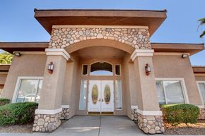 Henderson apartment for rent - A house with a stone archway entrance and two doors.