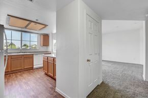 Henderson apartment for rent - A kitchen with wooden cabinets and a white door.