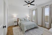 Tallahassee townhouse for rent - A bedroom with a bed, nightstands, and a ceiling fan.