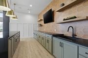 Tallahassee townhouse for rent - A kitchen with a black counter top and wooden shelves.