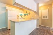 Las Vegas apartment for rent - A kitchen with white cabinets and a white fridge.