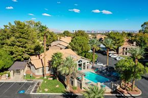 Las Vegas apartment for rent - A bird's eye view of a residential area with a swimming pool and palm trees.