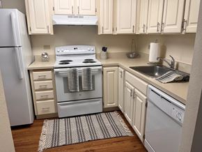 Daytona Beach apartment for rent - A kitchen with a white oven and white cabinets.