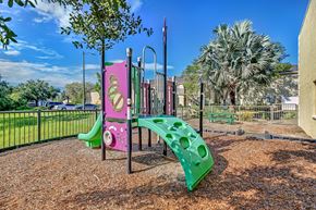 Tampa apartment for rent - A playground with a pink and green slide. at Westminster Chase Apartments, Florida