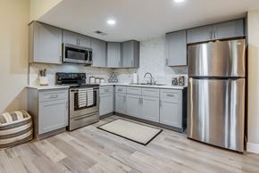 Deland apartment for rent - a kitchen with gray cabinets and stainless steel appliances