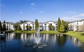 Riverview apartment for rent - A fountain in the middle of a pond in front of a building.