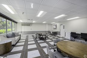 Sacramento apartment for rent - a conference room with tables and chairs and a projector screen