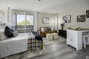 Sacramento apartment for rent - a bedroom with a bed and a large window