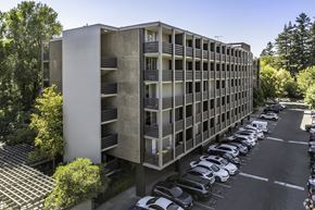 Sacramento apartment for rent - an office building with cars parked in a parking lot