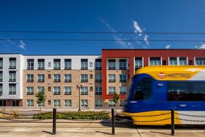 Saint Paul apartment for rent - a train passes in front of a building