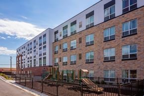 Saint Paul apartment for rent - a large brick building with a playground in front of it