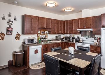 Saint Paul apartment for rent - a kitchen with wooden cabinets and a dining table