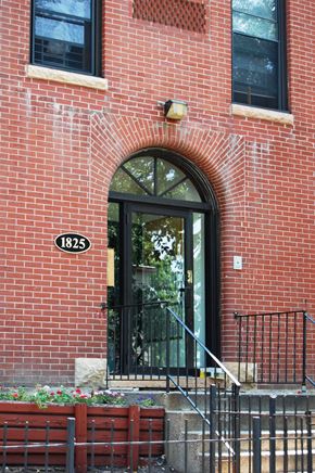 Minneapolis apartment for rent - A red brick building with a black door and a number 1825 on the front.