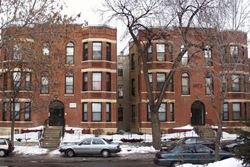 Minneapolis apartment for rent - A red brick building with a black door and windows.
