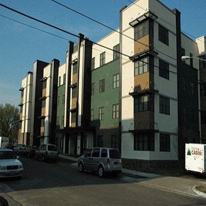 Minneapolis apartment for rent - A white car is parked in front of a multi-story building.