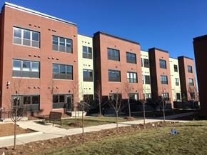Minneapolis apartment for rent - A row of red brick apartment buildings with trees in front.