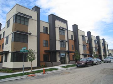 Minneapolis apartment for rent - Apartment building with a brown and beige exterior and a green tree in front.