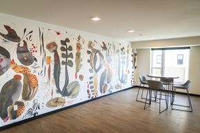 Saint Paul apartment for rent - A dining room with a large mural of various plants on the wall.